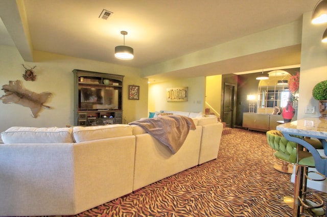 living room featuring stairs, carpet, and visible vents