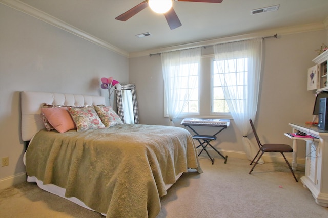 carpeted bedroom with baseboards, visible vents, ceiling fan, and ornamental molding