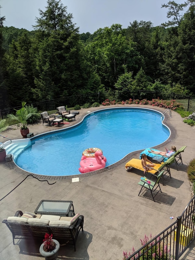 view of pool with a fenced backyard, a fenced in pool, and a patio