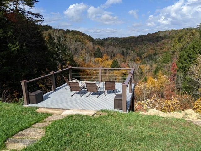 wooden deck featuring a view of trees