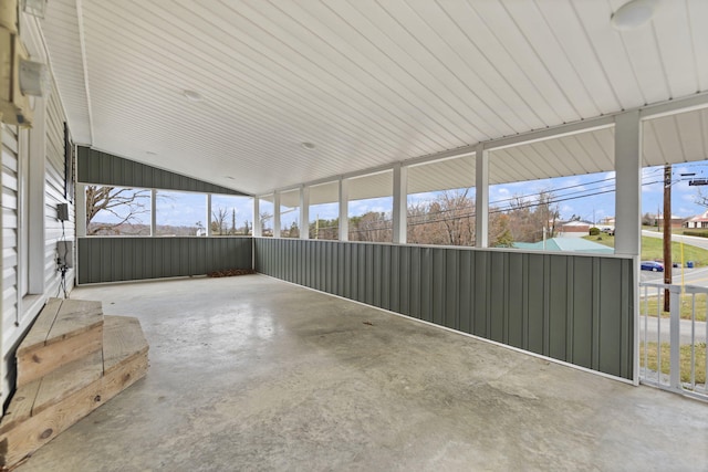 unfurnished sunroom with vaulted ceiling