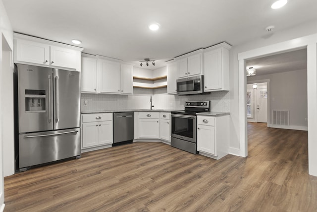 kitchen with white cabinetry, dark hardwood / wood-style flooring, and appliances with stainless steel finishes