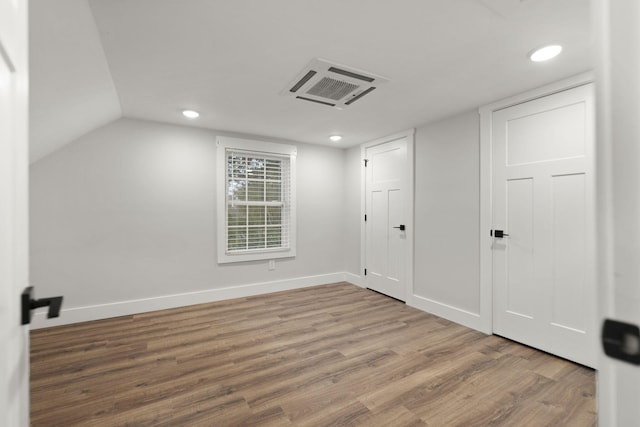 bonus room featuring wood-type flooring and lofted ceiling