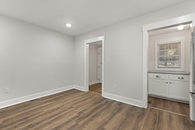 unfurnished bedroom featuring dark hardwood / wood-style floors