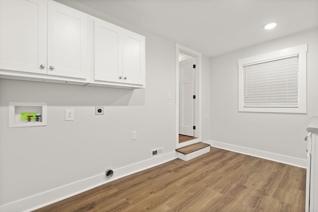 laundry area with cabinets, wood-type flooring, washer hookup, and hookup for an electric dryer