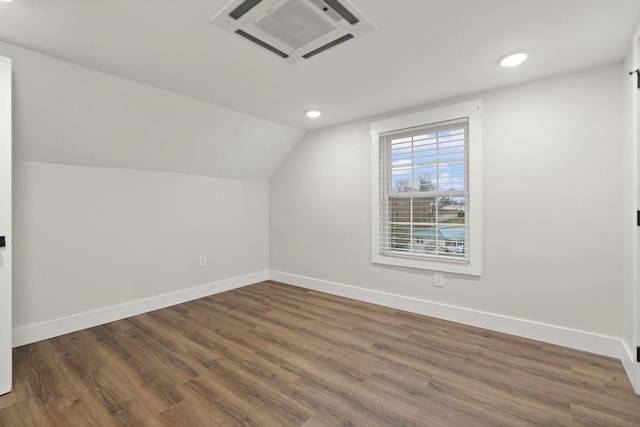 bonus room featuring dark wood-type flooring and lofted ceiling