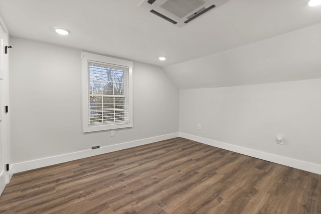 bonus room featuring lofted ceiling and dark wood-type flooring