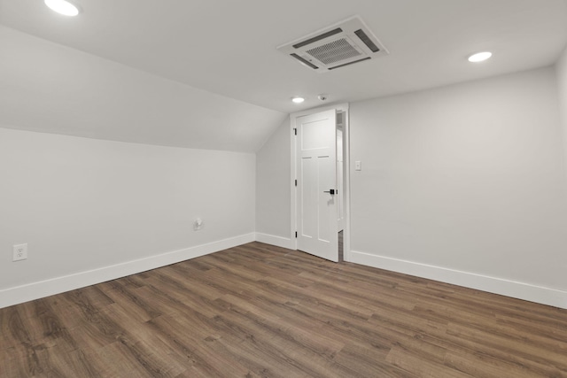 bonus room with lofted ceiling and dark wood-type flooring