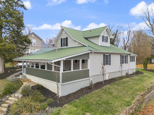 view of home's exterior featuring a porch and a yard