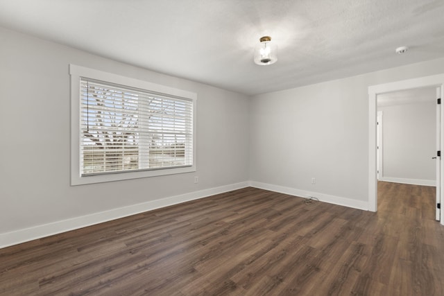 spare room featuring dark hardwood / wood-style flooring