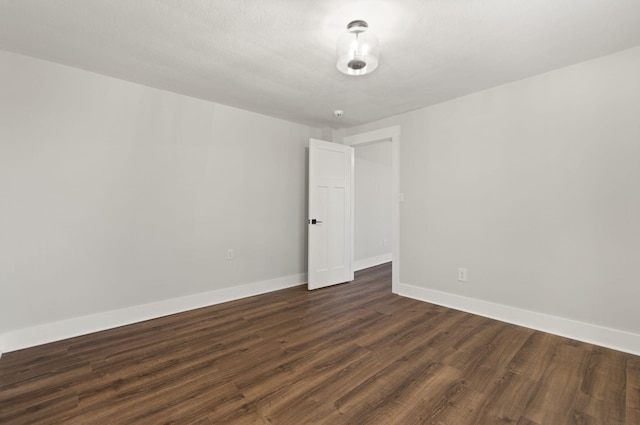 empty room featuring dark wood-type flooring