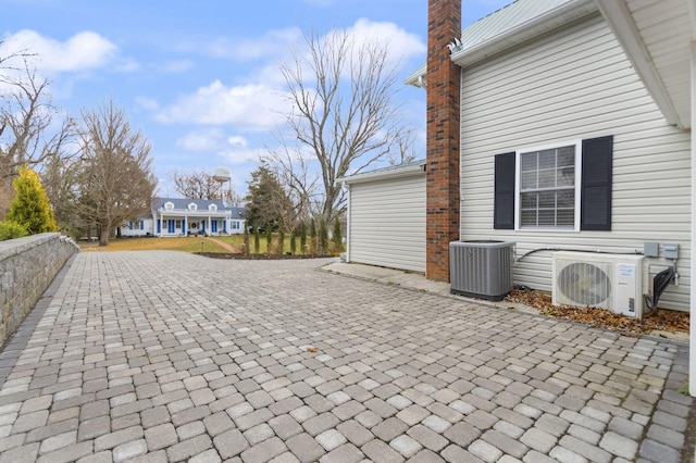 view of patio with ac unit and cooling unit