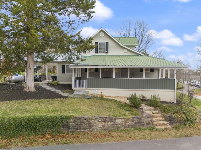 farmhouse with covered porch and a front lawn