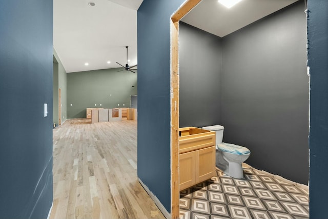 bathroom featuring ceiling fan, wood-type flooring, and toilet