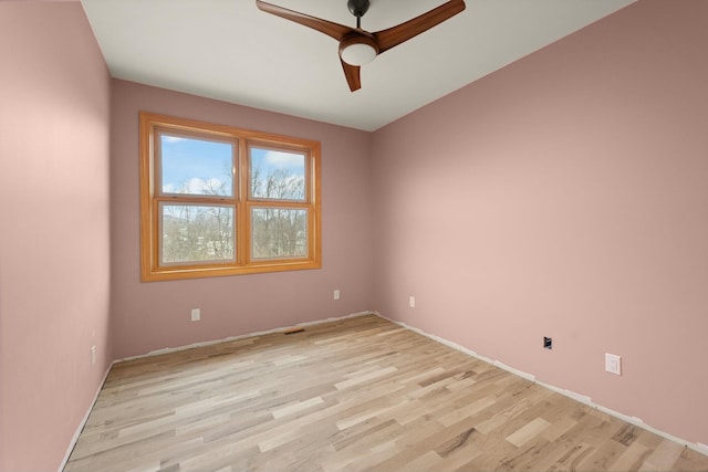 spare room with light wood-type flooring and ceiling fan