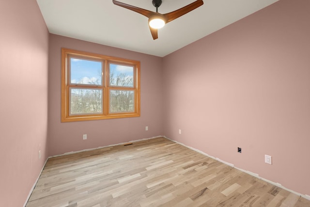 empty room featuring ceiling fan and light wood-type flooring