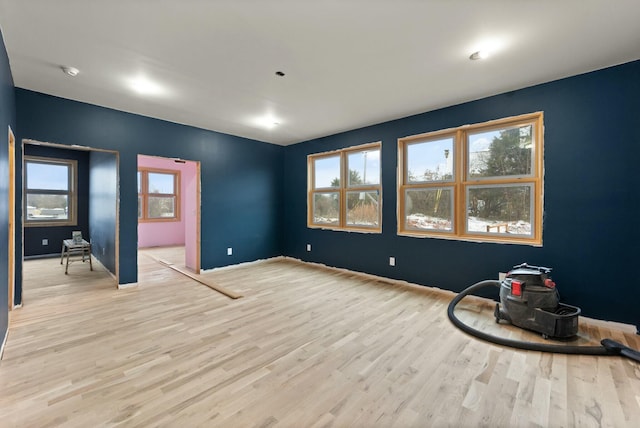 unfurnished room with light wood-type flooring