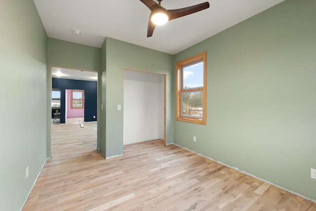 unfurnished bedroom with ceiling fan, a closet, and light hardwood / wood-style flooring