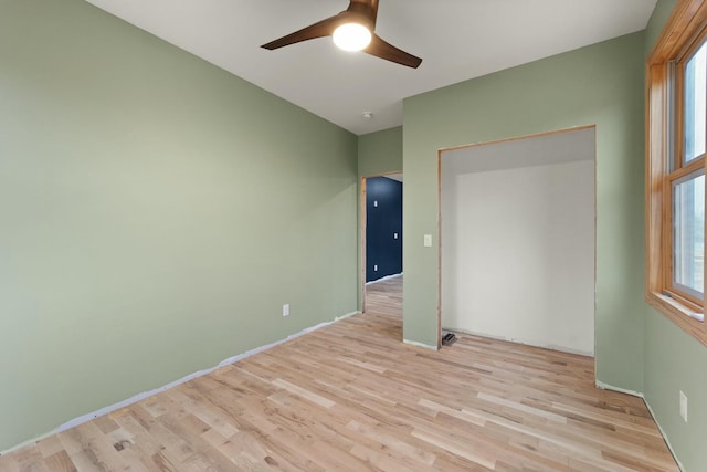 unfurnished bedroom with ceiling fan and light hardwood / wood-style flooring