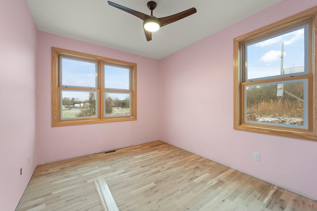 unfurnished room with ceiling fan and light hardwood / wood-style floors