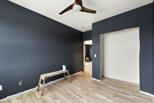 empty room featuring ceiling fan and light hardwood / wood-style flooring