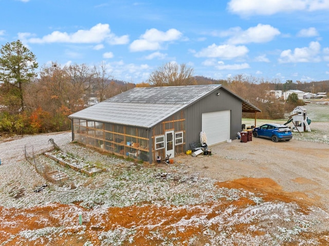 view of home's exterior featuring a garage and an outdoor structure