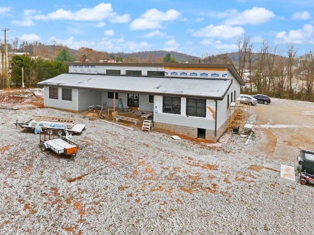 back of property with a mountain view