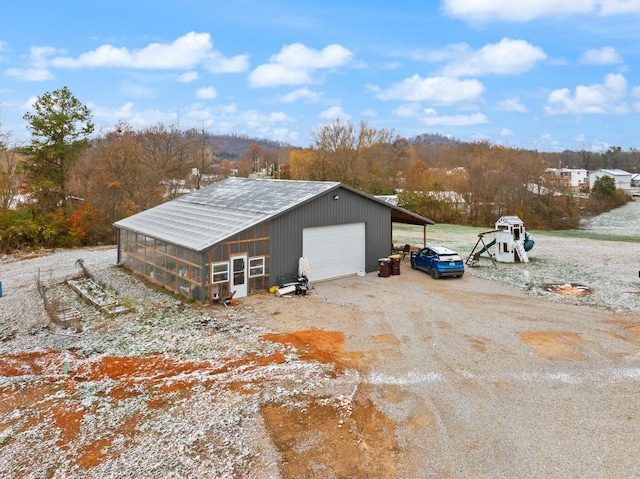 view of outdoor structure featuring a carport and a garage