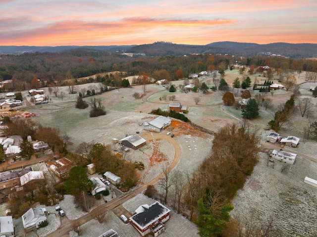 aerial view at dusk featuring a mountain view