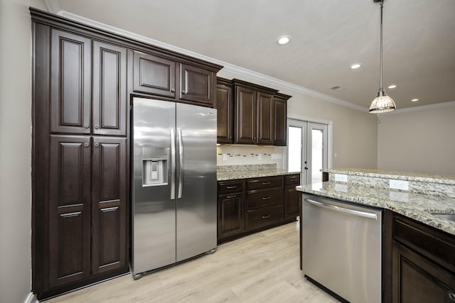 kitchen featuring pendant lighting, light hardwood / wood-style flooring, ornamental molding, appliances with stainless steel finishes, and dark brown cabinets