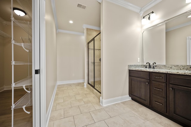 bathroom with crown molding, tile patterned flooring, vanity, and a shower with shower door