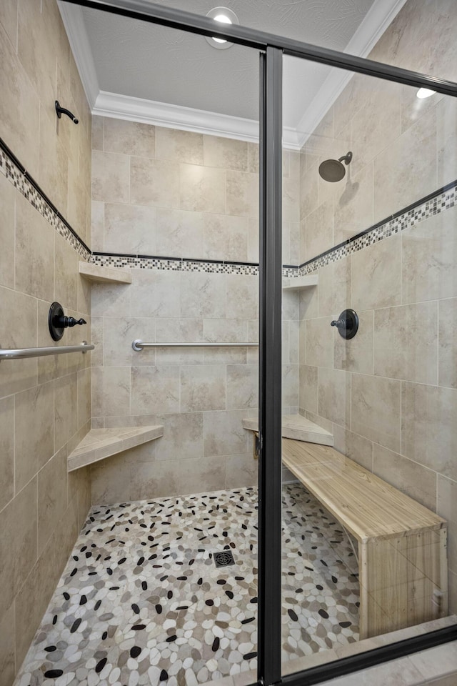 bathroom with crown molding and an enclosed shower