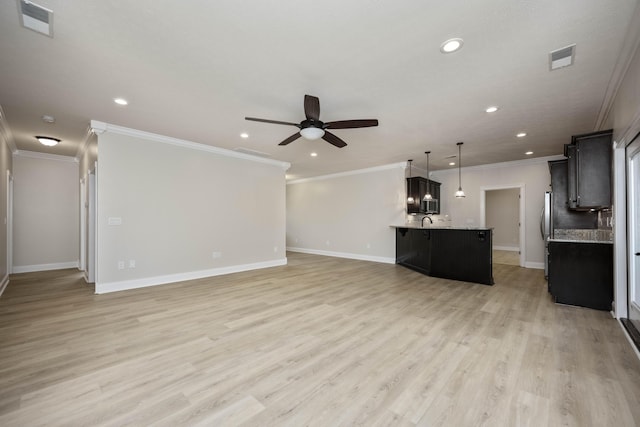 unfurnished living room featuring ceiling fan, ornamental molding, sink, and light hardwood / wood-style flooring