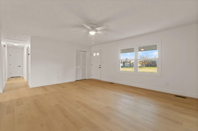 spare room with ceiling fan and light wood-type flooring