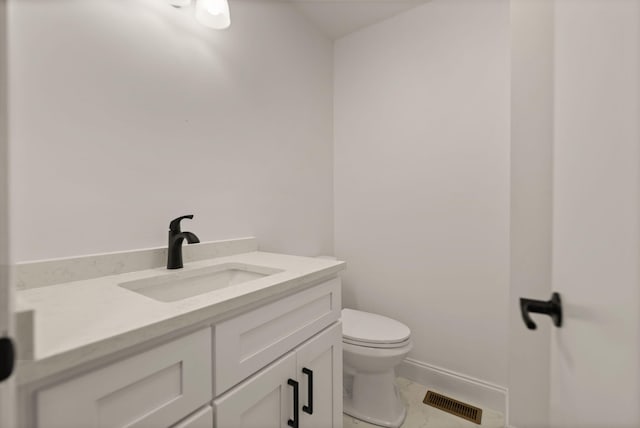 bathroom featuring tile patterned floors, vanity, and toilet