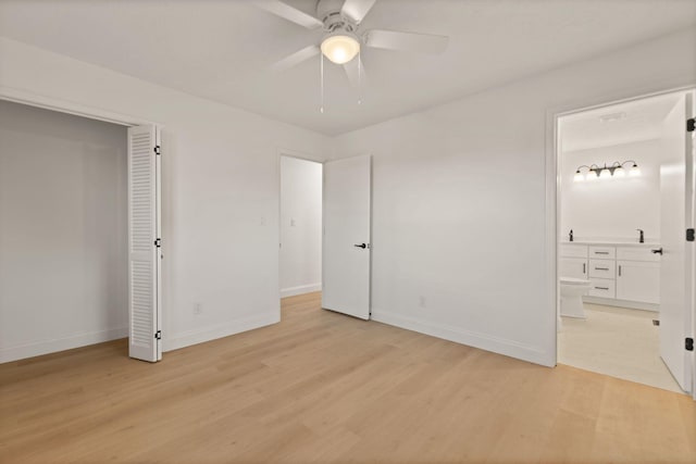 unfurnished bedroom featuring connected bathroom, light hardwood / wood-style flooring, and ceiling fan