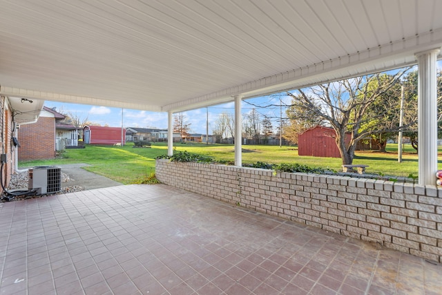 view of patio / terrace featuring a storage shed and central air condition unit