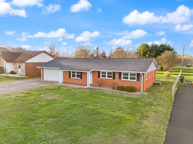 ranch-style house with a front yard and a garage