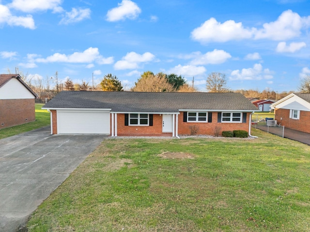 single story home featuring a garage and a front yard