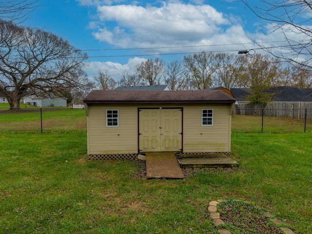 view of outbuilding with a yard