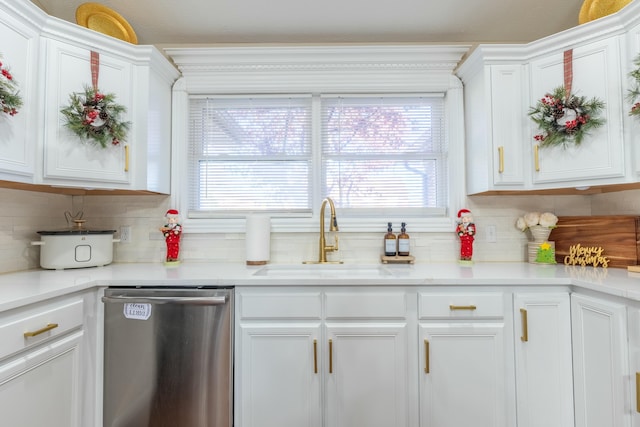 kitchen featuring dishwasher, white cabinets, tasteful backsplash, and sink