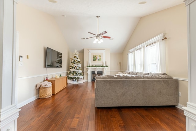 living room with dark hardwood / wood-style floors, ceiling fan, and lofted ceiling