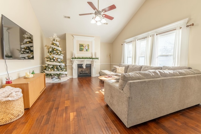 living room featuring ceiling fan, dark wood-type flooring, and high vaulted ceiling