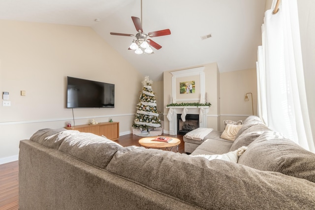 living room with ceiling fan, dark hardwood / wood-style flooring, and high vaulted ceiling