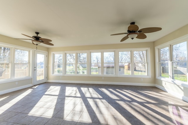 unfurnished sunroom featuring a wealth of natural light and ceiling fan