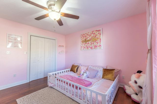 bedroom with ceiling fan, dark hardwood / wood-style flooring, and a closet