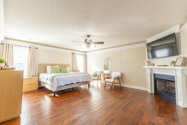 bedroom with hardwood / wood-style flooring, ceiling fan, crown molding, and a textured ceiling