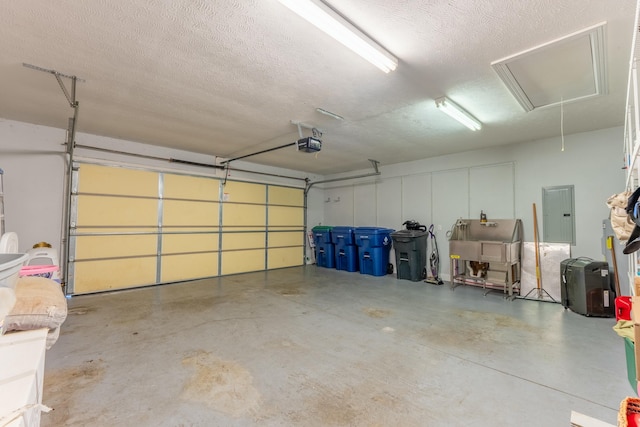 garage with electric panel and a garage door opener