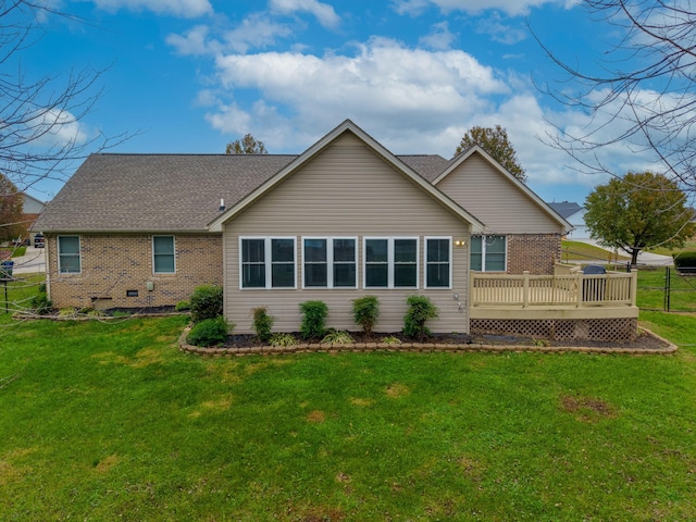 rear view of house with a yard and a wooden deck