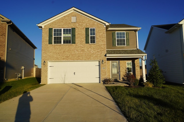 view of front of house featuring a front yard and a garage